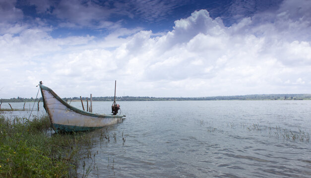 An Awesome panoramic picture of the kabini backwater with a wooden boat and vibrant sky makes for perfect travel destinations  in Karnataka,India.