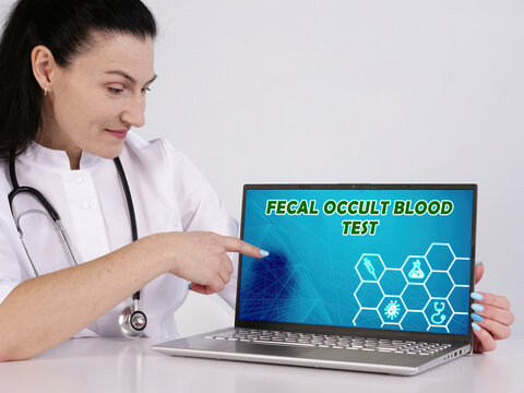 FOBT FECAL OCCULT BLOOD TEST text in search line. Doctor looking for something at computer.