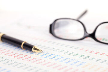 Financial charts and ballpoint pens