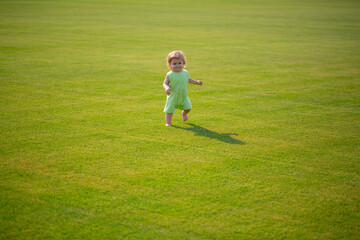 Healthy child. Baby boy toddler walking in a park on bright spring day.