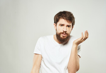 Fototapeta premium The guy gestures with his hands a puzzled look of emotion of bewilderment