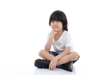 Happy Asian child sitting on white background,isolated