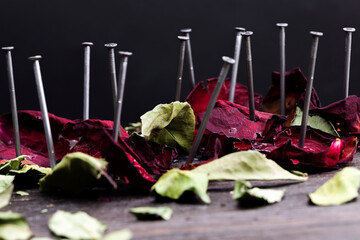 dried red rose on a black wooden board