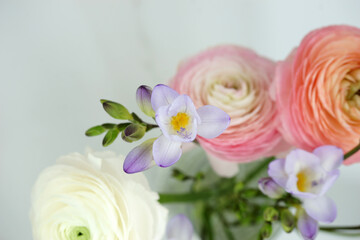 Obraz na płótnie Canvas Beautiful bouquet with spring ranunculus and freesias