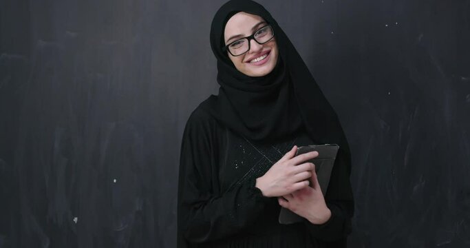 Muslim business woman holding tablet computer wearing hijab clothes