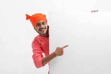 Young indian farmer holding white card board on white background.