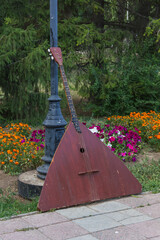 musical instrument balalaika leaning against a pole © Nurlan Tastanbekov