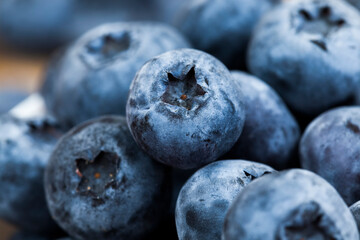 ripe juicy and tasty blueberries in large quantities on a wooden table