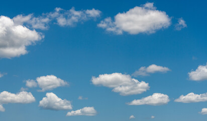 Naklejka na ściany i meble Cumulus clouds in a blue sky
