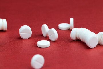 medicines for the treatment of diseases scattered on a red background