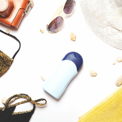 Summer vacation and travel concept. Beach accessories things - hat, swimsuit, sunglasses, camera, sunscreen, white background. Summer is coming trendy concept