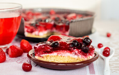 a piece of berry pie closeup, a cake decorated with strawberries and black currants in jelly, healthy nutrition, vegan dessert