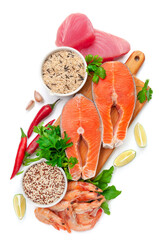 Fillet of tuna and salmon. Shrimp. On a wooden board. Garnished with herbs and spices. Next to them are cups of wild rice and quinoa. White background. Isolated. Close-up. View from above.