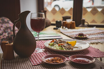 Grilled ribeye beef steak with red wine, herbs and spices on wooden table