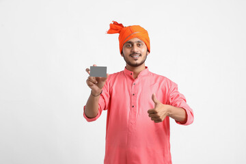 Young indian farmer showing card on white background