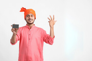 Young indian farmer showing card on white background