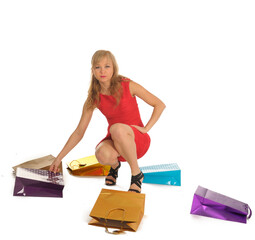 Young woman in a red dress with shopping bags. isolated on white