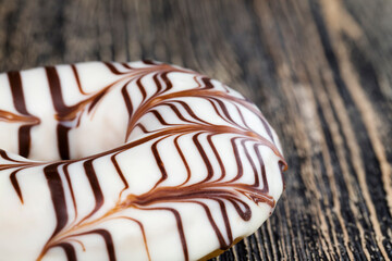 a fresh doughnut covered with white chocolate , closeup