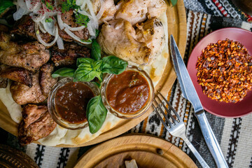 The richly laid table dishes of Georgian cuisine, lots of delicious food,wine,fruits and roasted meat