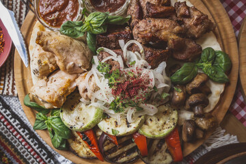 The richly laid table dishes of Georgian cuisine, lots of delicious food,wine,fruits and roasted meat