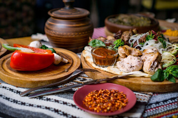 The richly laid table dishes of Georgian cuisine, lots of delicious food,wine,fruits and roasted meat