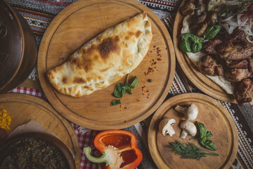 Traditional Georgian adjara khachapuri and Kolkh khachapuri on the table. Homemade baking. Top view. Flat lay