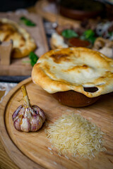 The concept of oriental cuisine. Homemade georgian Uzbek pilaf or plov from lamb served in cast iron cookware. Copy space.
