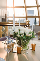 a bouquet of white roses on a preserved wooden table against the background of the dome from the windows