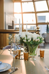 a bouquet of white roses on a preserved wooden table against the background of the dome from the windows