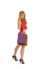 Young beautiful woman with some shopping bags and hamburger isolated on white