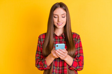 Portrait of nice brunette long hairdo lady look telephone wear red shirt isolated on vivid yellow color background