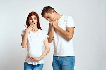 young married couple parents hug joy light background