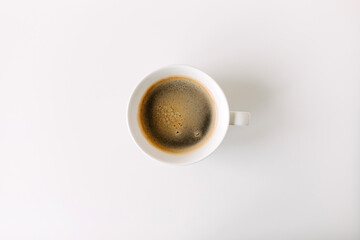 Cup of coffee on white table.