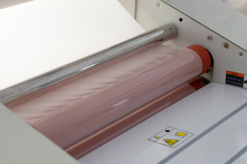 macro close-up machine for laminating paper or tags in the factory.