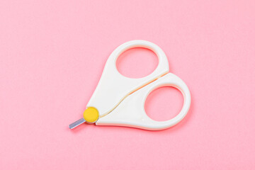 safe scissors for babies on pastel pink background .