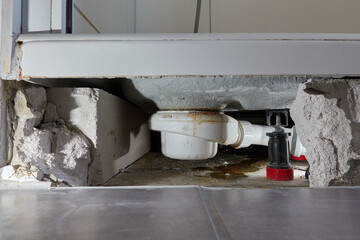 Leaking siphon of a shower tray in the bathroom, causes water damage. Tiles and masonry were...