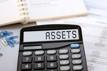 Calculator with the word Assets on the display