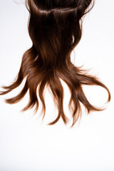 Fototapeta premium Hair waves curls lie on a white background