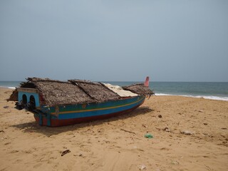 Wooden fishing boat on the seashore, Adimalathura beach, seascape view Thiruvananthapuram Kerala