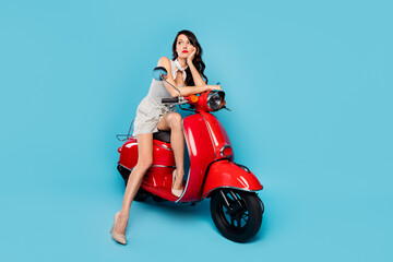 Fototapeta na wymiar Full size photo of young beautiful bored thoughtful woman thinking sit red motorcycle isolated on blue color background