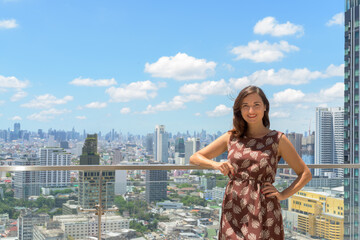 Portrait of beautiful woman outdoors at rooftop with city view