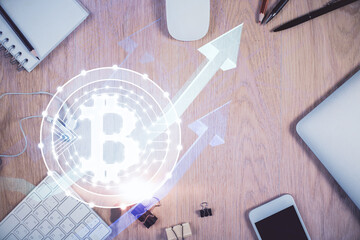 Double exposure of blockchain theme hologram over table with phone. Top view. Crypto technology...