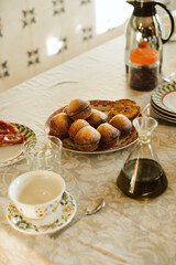 Table with a plate of muffins and cup of coffee
