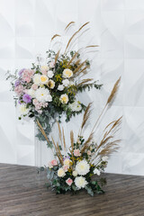 wedding reception area with fresh flowers in the white hall