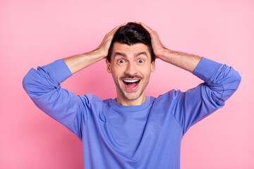 Portrait of impressed cheerful person arms on head open mouth isolated on pastel pink color background