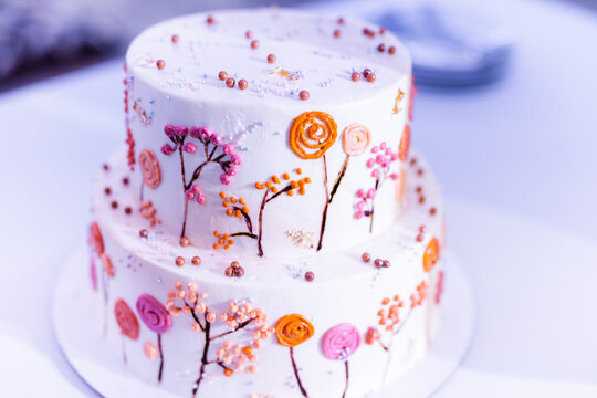 wedding cake in two tiers with autumn pictures