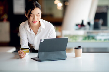 Portrait of Young woman using credit card and tablet for buying online shopping at home ,payment,buying and online shopping concept.