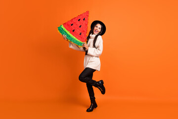 Fototapeta na wymiar Full size photo of young charming smiling cheerful excited girl hold huge slice watermelon isolated on orange color background