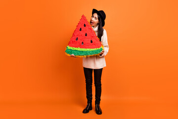 Full size photo of young beautiful funky funny crazy woman ear huge slice of watermelon isolated on orange color background