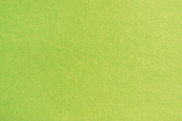 A sheet of colored paper with a non-uniform color. Neutral paper texture.